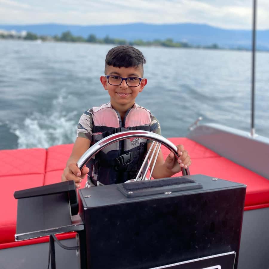 Kelowna: Private Boat Tour with Bluetooth Speaker - Steering the boat in Kelowna, plus the kid factor