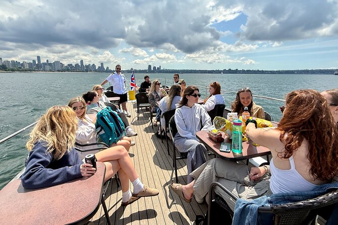 Vancouver Sightseeing Boat Cruise with Live Tour Guide - Stanley Park shoreline, Siwash Rock meaning, and Lions Gate bridge views